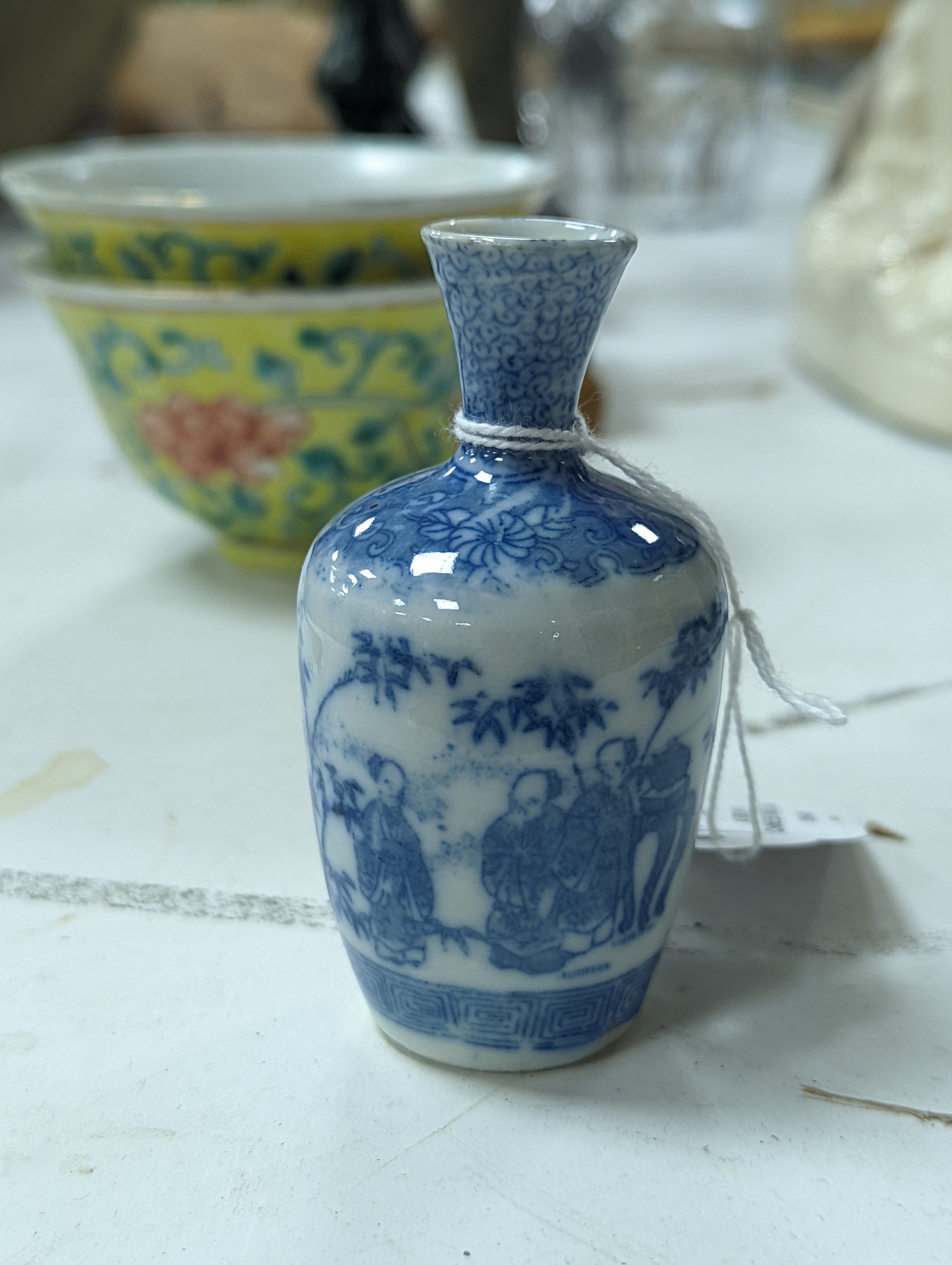 A group of Chinese porcelain, 19th /20th century, to include a pair of yellow ground bowls, 10.8 cm diameter, a blue and white vase, Xuande mark, a similar bowl and vase, and a champleve enamel bronze koro and cover